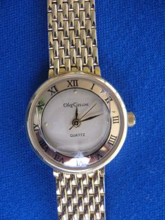 Ladies goldtone white round faced Oleg Cassini quartz watch