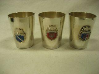 vintage silver plated shot glasses w/ crest logos