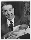 1951 Notre Dame Football Coach Frank Leahy shows off new daughter Wire 