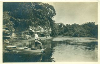 rppc man standing, fishing out of small boat fox river illinois