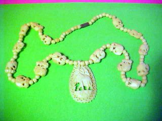 VINTAGE HAND CARVED FAUX IVORY ELEPHANT NECKLACE down