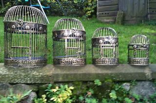 small sized gold coloured ornate iron oriental bird cage time