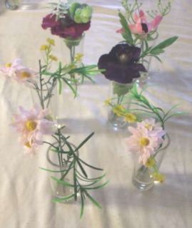   are bidding on 6 arrangements in a 4 inch glass vase with fake water