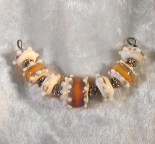 the delightful set of 7 beads is made with ribbons of amber
