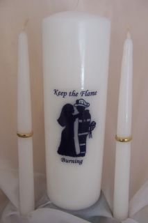 The pillar candle has a fireman and his bride. The couple are done in