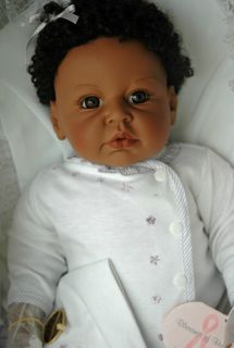 of Hope a 20 newborn doll with dark skin tone, brown hair and brown