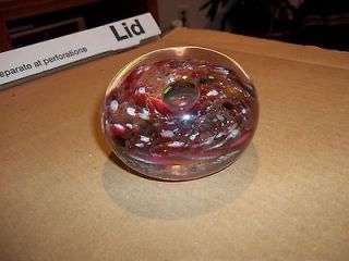 Vintage glass paperweight with red cranberry design inside