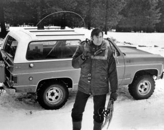 Clint Walker Standing Next to his Blazer Truck in the Snow